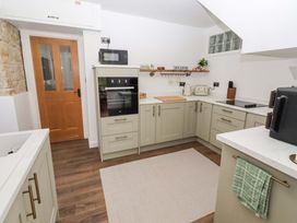 A kitchen with appliances and cabinets at The Lodge Powburn