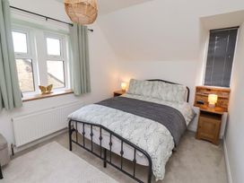 A bedroom with a bed and bedside table at The Lodge in Powburn