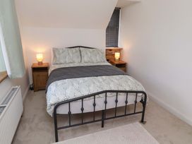 A bedroom with a bed and nightstand at The Lodge in Powburn