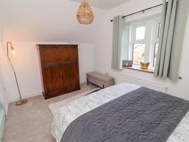 A bedroom with a bed and wardrobe at The Lodge in Powburn