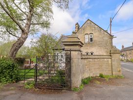 A house with a gate and tree near the road at The Lodge in Powburn