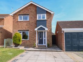 The front exterior of a two-story brick house with a driveway and a garage at 6 Barleycroft in Hemsby