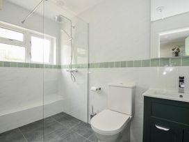 A bathroom with a shower, toilet, and sink at 2 Porthilly Cottages in Rock