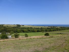 A landscape view of fields and ocean at Meadow Cottage in Staintondale near Cloughton