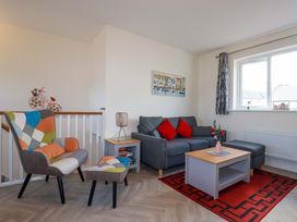 A living room with a sofa and armchair at 1 Vetch Avenue St Austell