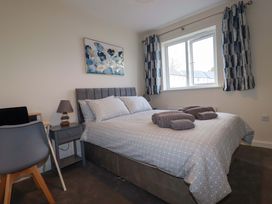 A bedroom with a double bed and a bedside table at 1 Vetch Avenue St Austell