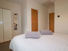 A bedroom with a bed and wardrobe at 1 Vetch Avenue St Austell