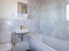 A bathroom with a toilet, sink, and bathtub at 1 Vetch Avenue St Austell