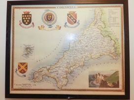 A map of Cornwall with coats of arms and illustration at 1 Vetch Avenue St Austell