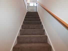 Stairs leading to a landing with a window at 1 Vetch Avenue St Austell