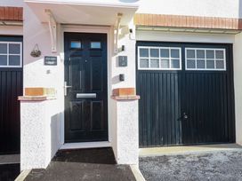 An entrance with a front door and garage door at 1 Vetch Avenue St Austell