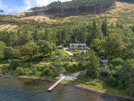 An outdoor area with a house, dock, and garden at Deer Close Coniston