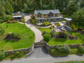 An outdoor view of a house with a garden and driveway at Deer Close, Coniston