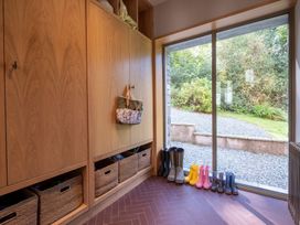 An entryway with storage cabinet and rain boots at Deer Close in Coniston