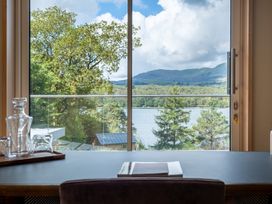 A window view of a lake and mountains at Deer Close in Coniston