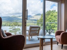 A living room with a view of mountains and water at Deer Close in Coniston