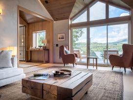 A living room with a coffee table and chairs at Deer Close in Coniston