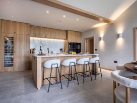 A kitchen with wooden cabinets and a central island at Deer Close in Coniston