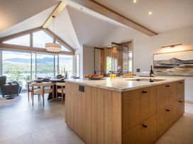 A kitchen with an island and dining area at Deer Close in Coniston