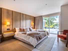 A bedroom with a bed and a sliding door at Deer Close in Coniston