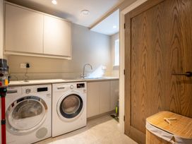 A laundry room with a washing machine and tumble dryer at Deer Close in Coniston