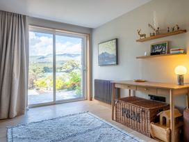 A living room with a view and a table at Deer Close in Coniston