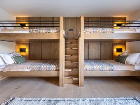A bedroom with bunk beds and a staircase at Deer Close in Coniston