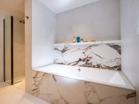 A bathroom with a bathtub and shower at Deer Close in Coniston