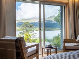 A view from a room overlooking a lake and mountains at Deer Close in Coniston