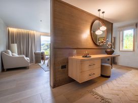 A bedroom with a table and mirror at Deer Close in Coniston