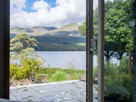 A view of a lake and mountains from a door at Deer Close in Coniston