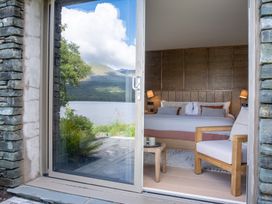 A bedroom with a bed and side table at Deer Close in Coniston