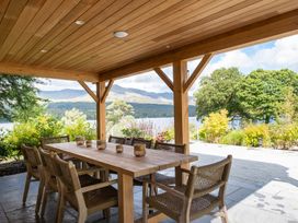An outdoor patio with a table and chairs at Deer Close in Coniston