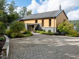 A house with a driveway and garden at Deer Close in Coniston