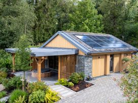 A house with solar panels and landscaped garden at Deer Close in Coniston
