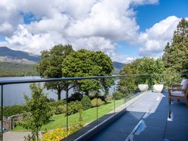 A balcony with outdoor furniture and planters at Deer Close in Coniston