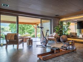 A gym with exercise equipment and large glass doors at Deer Close in Coniston