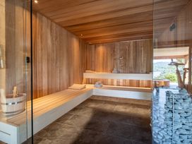 A sauna with wooden benches and towels at Deer Close in Coniston