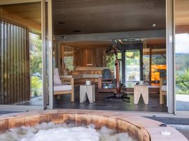 A hot tub with light bubbles and wooden furniture at Deer Close in Coniston