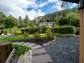 A garden with a stone path and lush greenery at Deer Close in Coniston