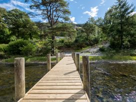 A wooden dock leading to water at Deer Close in Coniston