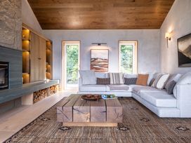A living room with a sofa, coffee table, and fireplace at Deer Close in Coniston