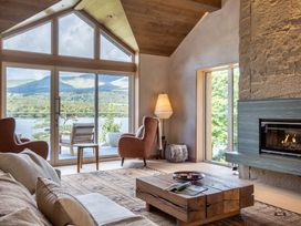 A living room with a fireplace and seating area at Deer Close in Coniston