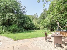 A garden with a seating area and hot tub at Roe Deer Lodge in Littlebeck near Sleights