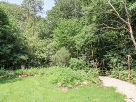A garden with greenery and a pathway at Roe Deer Lodge, Littlebeck near Sleights
