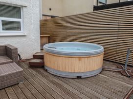 An outdoor area with a hot tub and seating at 51 Trinity Avenue Llandudno