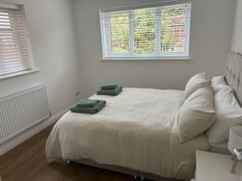 A bedroom with a bed and towels at 40 Gloddaeth View in Penrhyn Bay