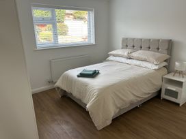 A bedroom with a bed and window at 40 Gloddaeth View in Penrhyn Bay