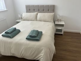 A bedroom with a bed and bedside table at 40 Gloddaeth View Penrhyn Bay