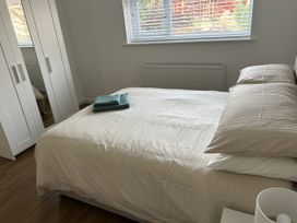 A bedroom with a bed and wardrobe at 40 Gloddaeth View in Penrhyn Bay